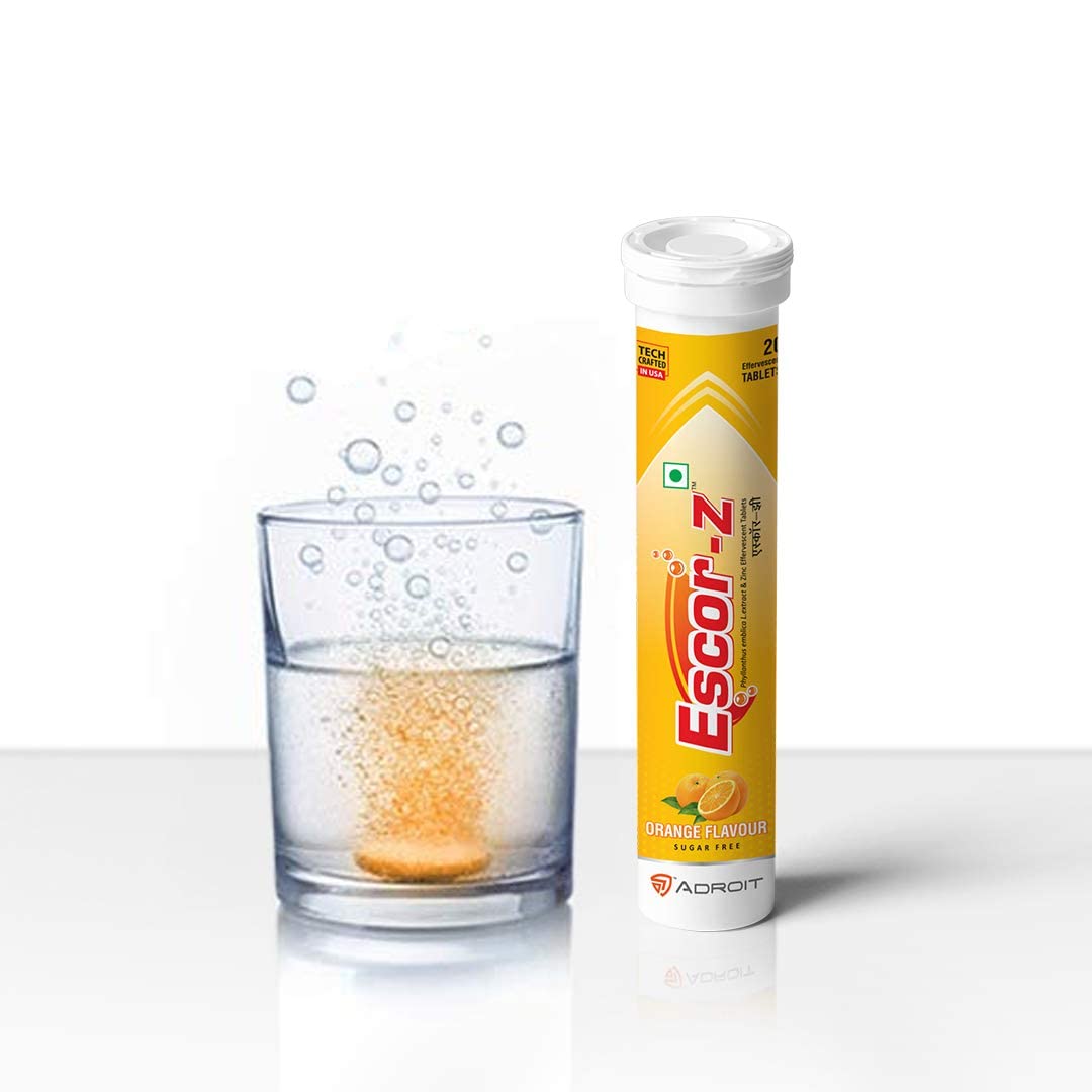 Escor-Z tablet being dissolved in a glass of water with the packaging on a white background
