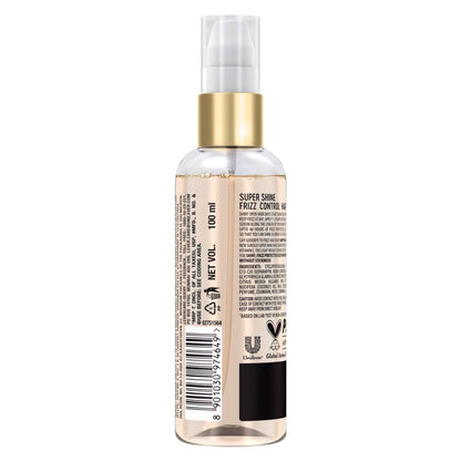 Clear spray bottle with gold cap on a white background