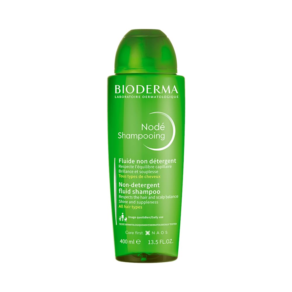 Green bottle of Bioderma Node Shampoo on a white background