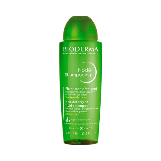 Green bottle of Bioderma Node Shampoo on a white background