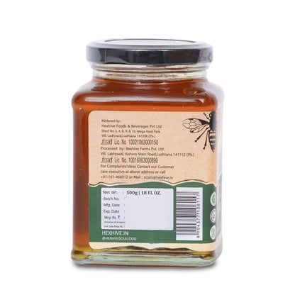 Jar of honey with a label on a white background