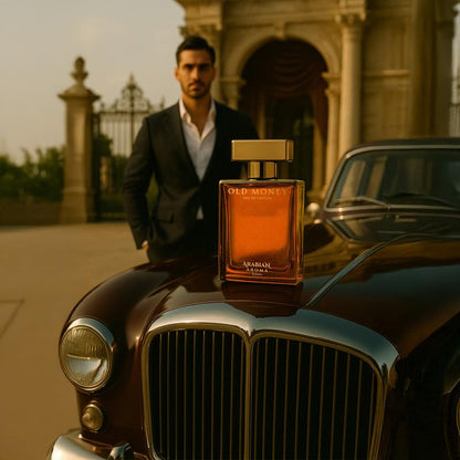 Man in a suit standing behind a vintage car with a perfume bottle on it, set against an architectural background.