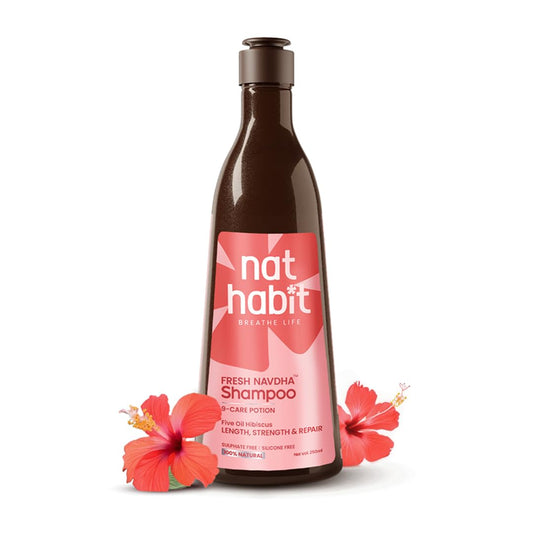 nat habit shampoo bottle with pink label and hibiscus flowers on a white background