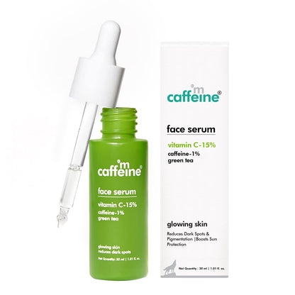Green face serum bottle with dropper and packaging on a white background