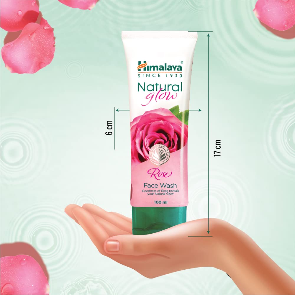 Himalaya Natural Glow Rose Face Wash tube with dimensions on a hand and rose petal background