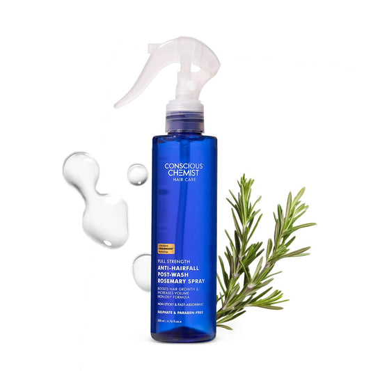 Blue bottle of Conscious Chemist hair care product with a rosemary branch on a white background