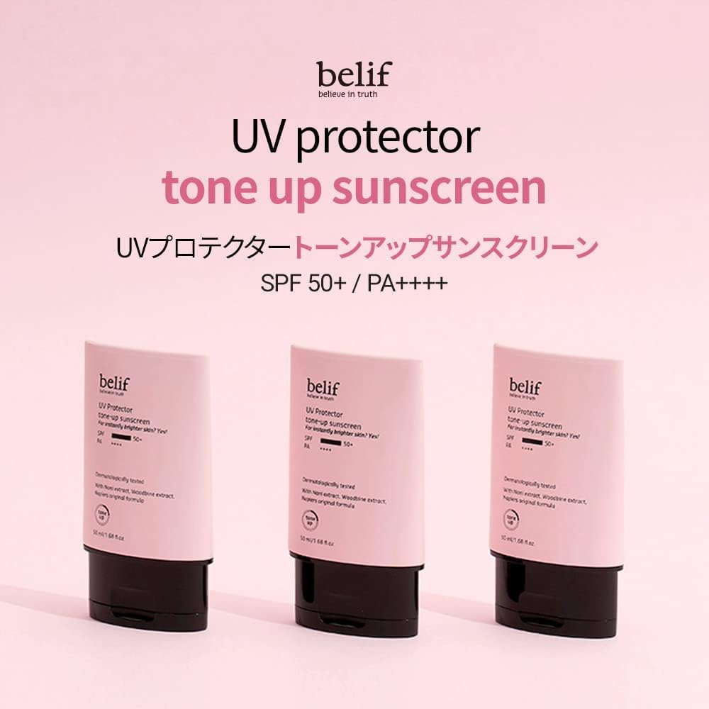 Three bottles of belif UV protector tone up sunscreen on a pink background
