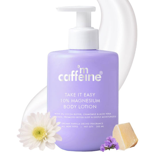 Purple bottle of caffeine-free magnesium body lotion with a white pump, surrounded by flowers and soap on a white background.