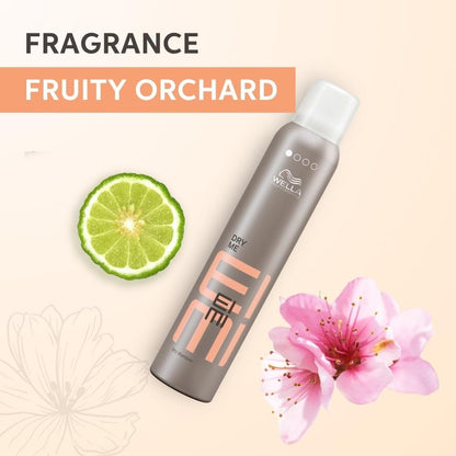 Wella EIMI hair product with lime and flower on a beige background