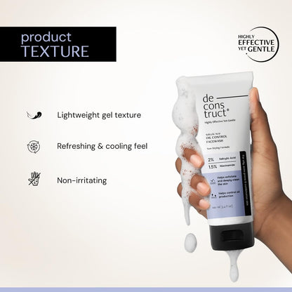 Hand holding a tube of 'de construct' skincare product with text on texture and benefits.