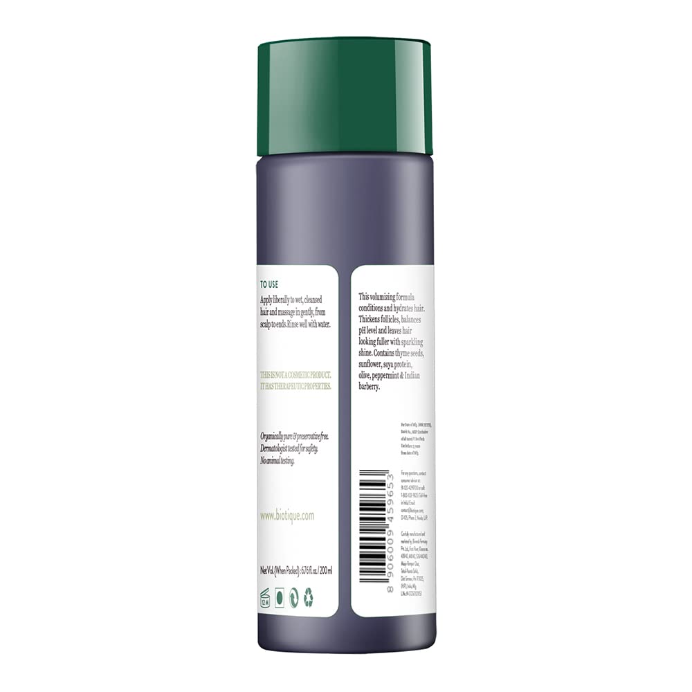 Back view of a cosmetic bottle with a green cap on a white background
