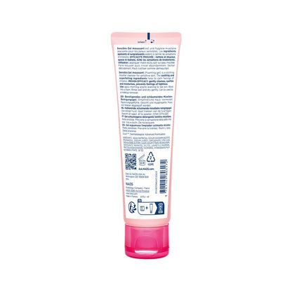 Pink tube with text and symbols on a white background