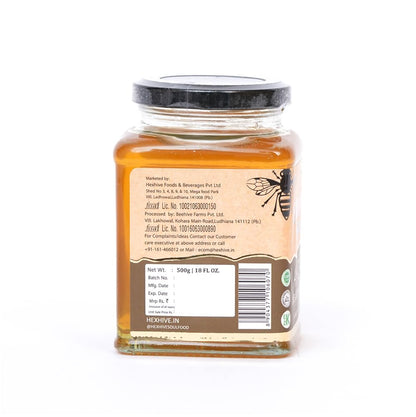 Jar of honey with a label on a white background