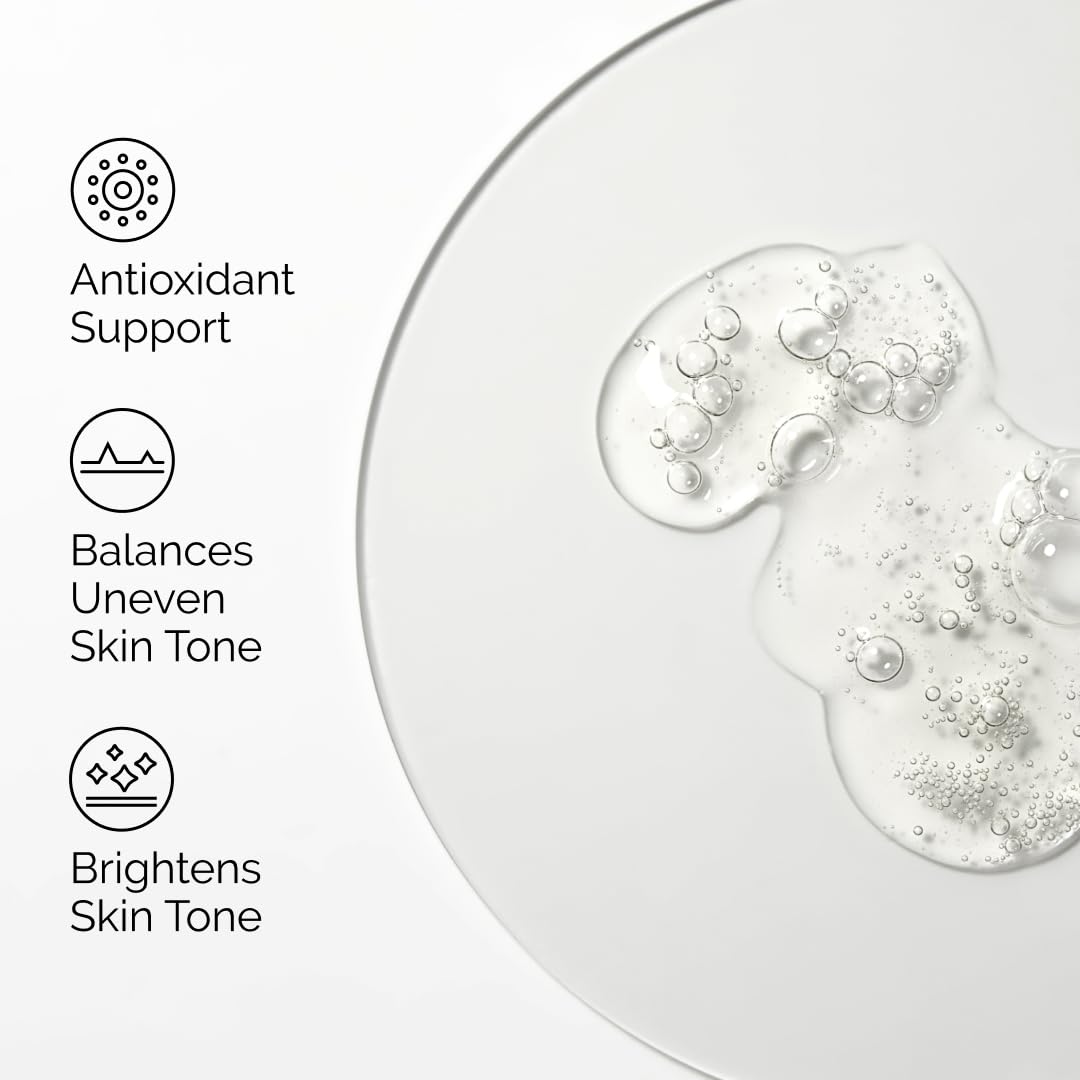 Skincare product with bubbles on a white background, featuring text on antioxidant support, skin tone balancing, and brightening.