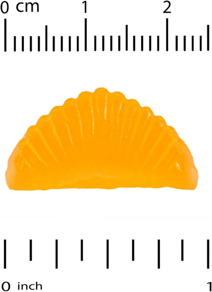 Orange gummy candy shaped like a fan with a ruler for scale on a white background
