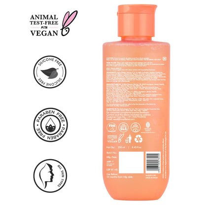 Peach-colored bottle with labels indicating animal test-free, vegan, silicone-free, paraben-free, and cruelty-free on a white background.