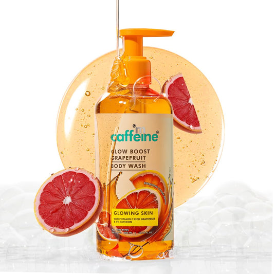 Grapefruit body wash bottle with pump and grapefruit slices on a white background