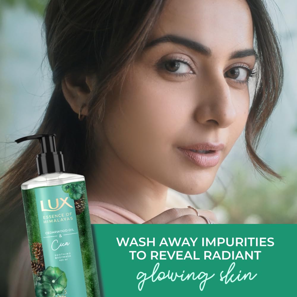 Woman with a bottle of Lux product against a blurred natural background