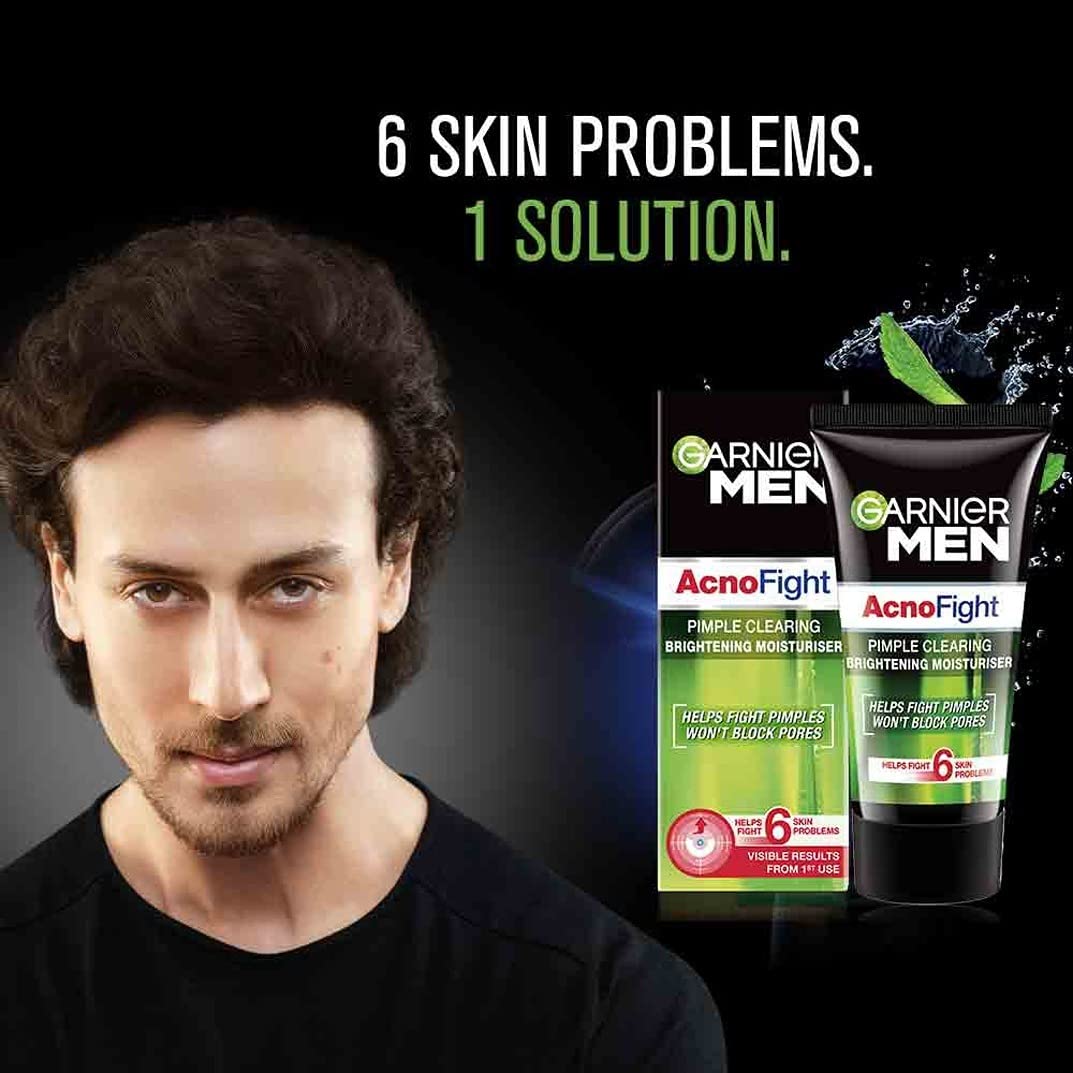 Garnier Men Acno Fight skincare products with a man's face on a dark background