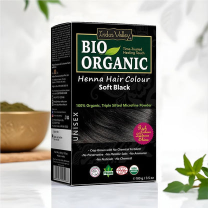 Box of Indus Valley Bio Organic Henna Hair Colour in Soft Black on a white background with greenery.