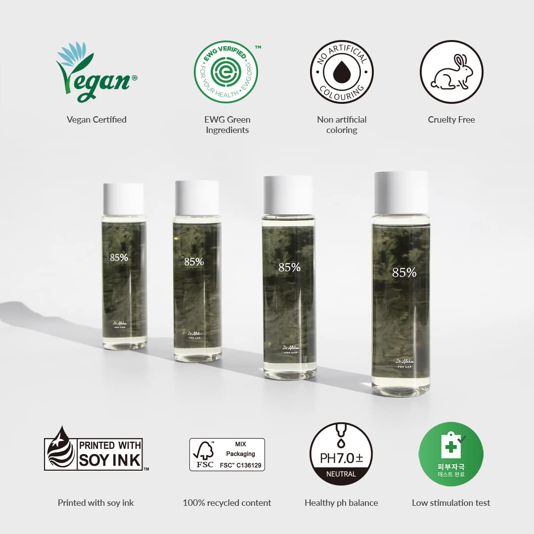 Four bottles of skincare product with certification logos on a white background