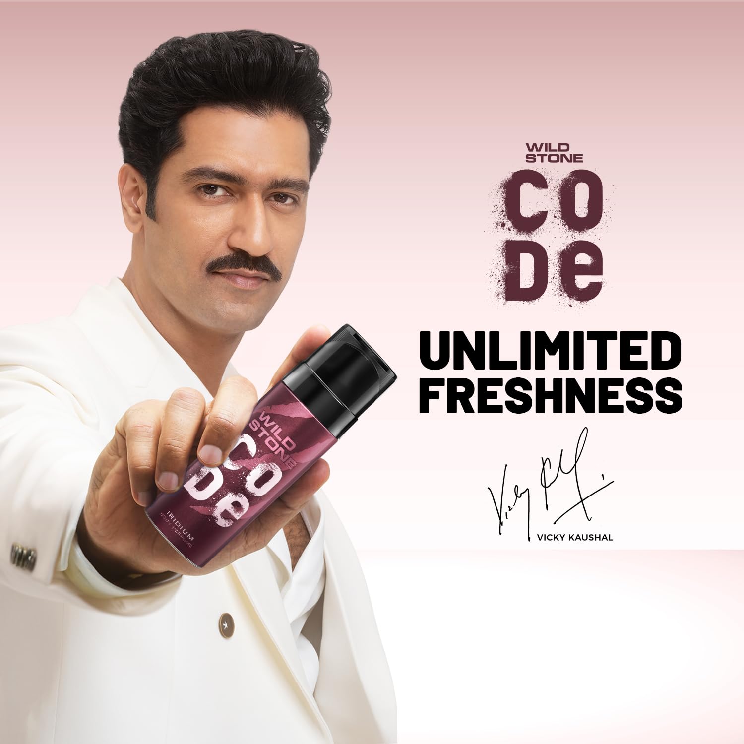 Person holding a Wild Stone product with 'Unlimited Freshness' text on a pink background