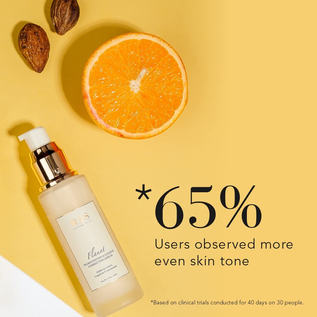 Skincare bottle with an orange slice and nuts on a yellow background