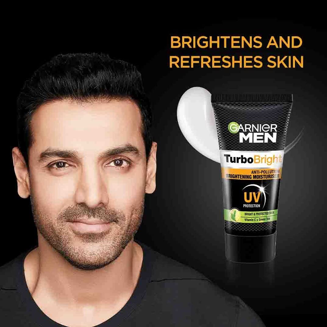 Man with a beard and Garnier Men Turbo Bright product on a black background