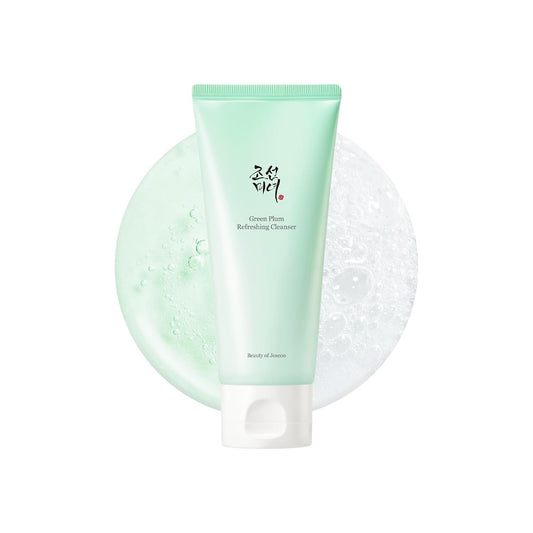 Green cleanser tube with a white base on a white background