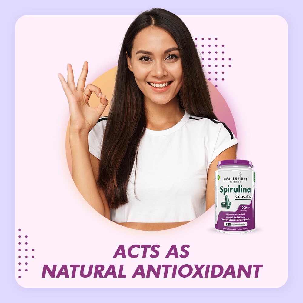 Woman making a peace sign with a Moringa supplement bottle on a light purple background