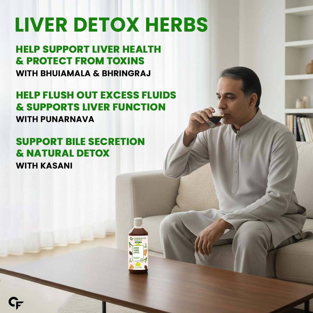 Man sitting on a couch drinking from a cup with liver detox herbs displayed around him.