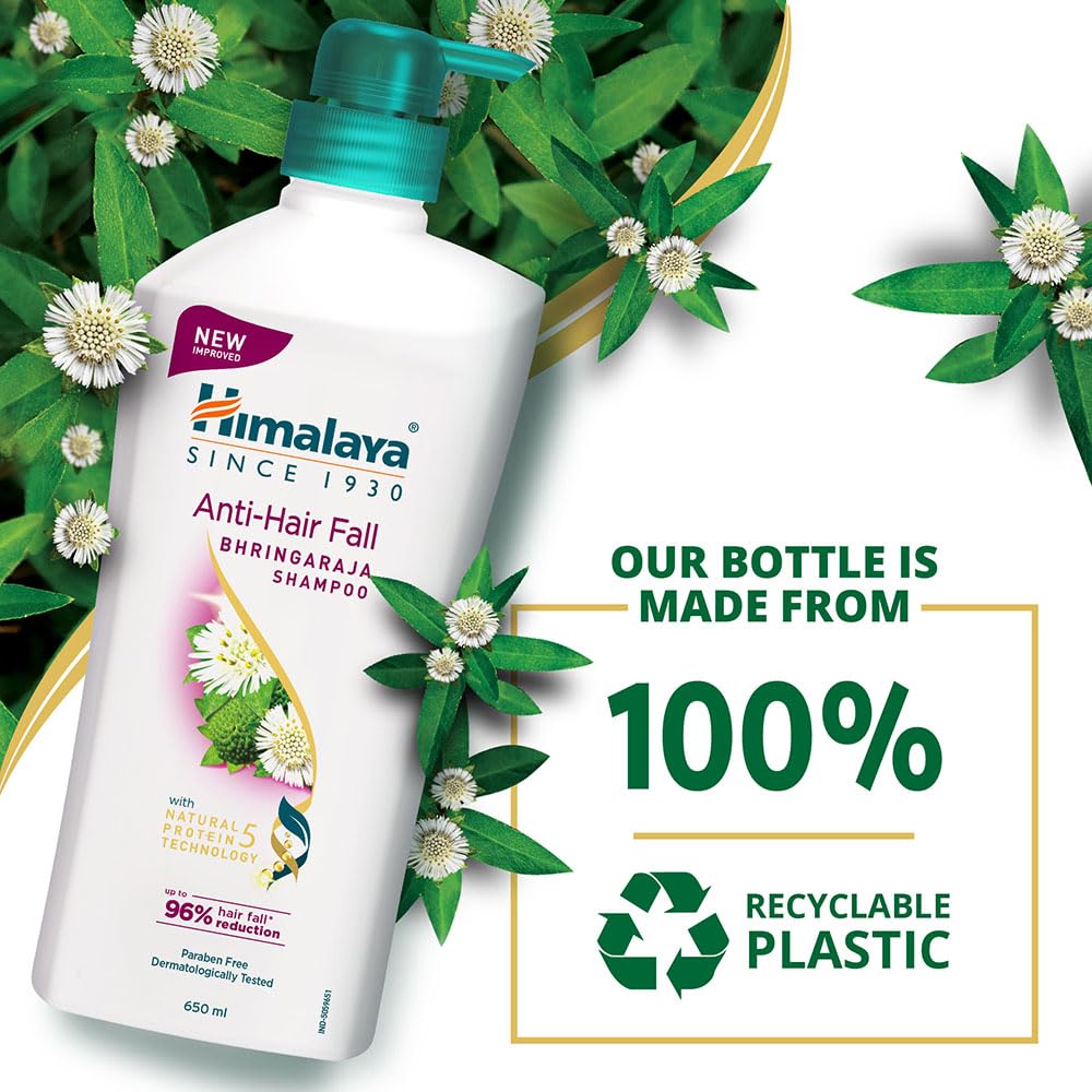 Himalaya Anti-Hair Fall Bhringaraja Shampoo bottle with recyclable plastic text and green leaves in the background