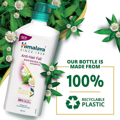 Himalaya Anti-Hair Fall Bhringaraja Shampoo bottle with recyclable plastic text and green leaves in the background