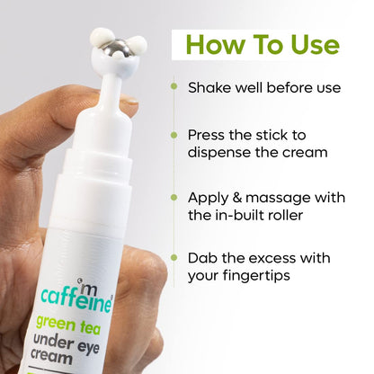 Hand holding a white under eye cream with usage instructions on a light gray background