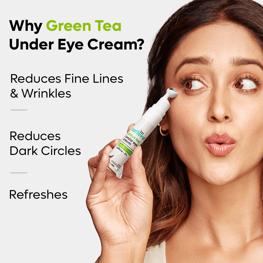 Woman applying eye cream with text about green tea eye cream benefits on a white background
