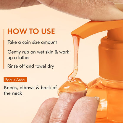 Orange bottle of soap with droplet on finger and usage instructions on beige background