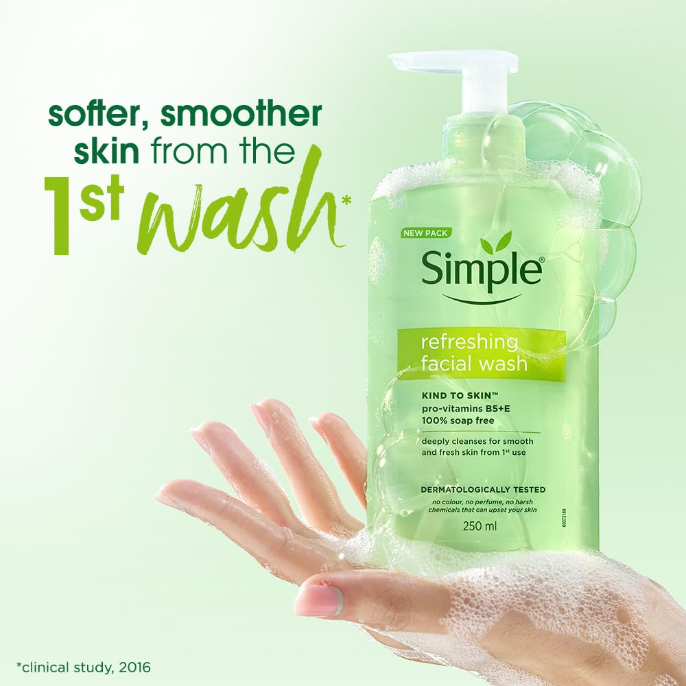 Green bottle of Simple refreshing facial wash with a hand holding it, on a light green background.
