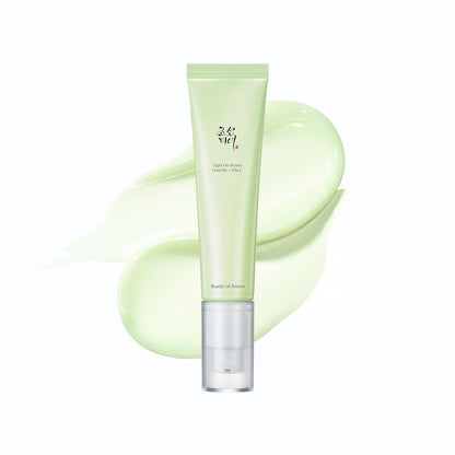 Skincare product with a green tube and bottle on a white background