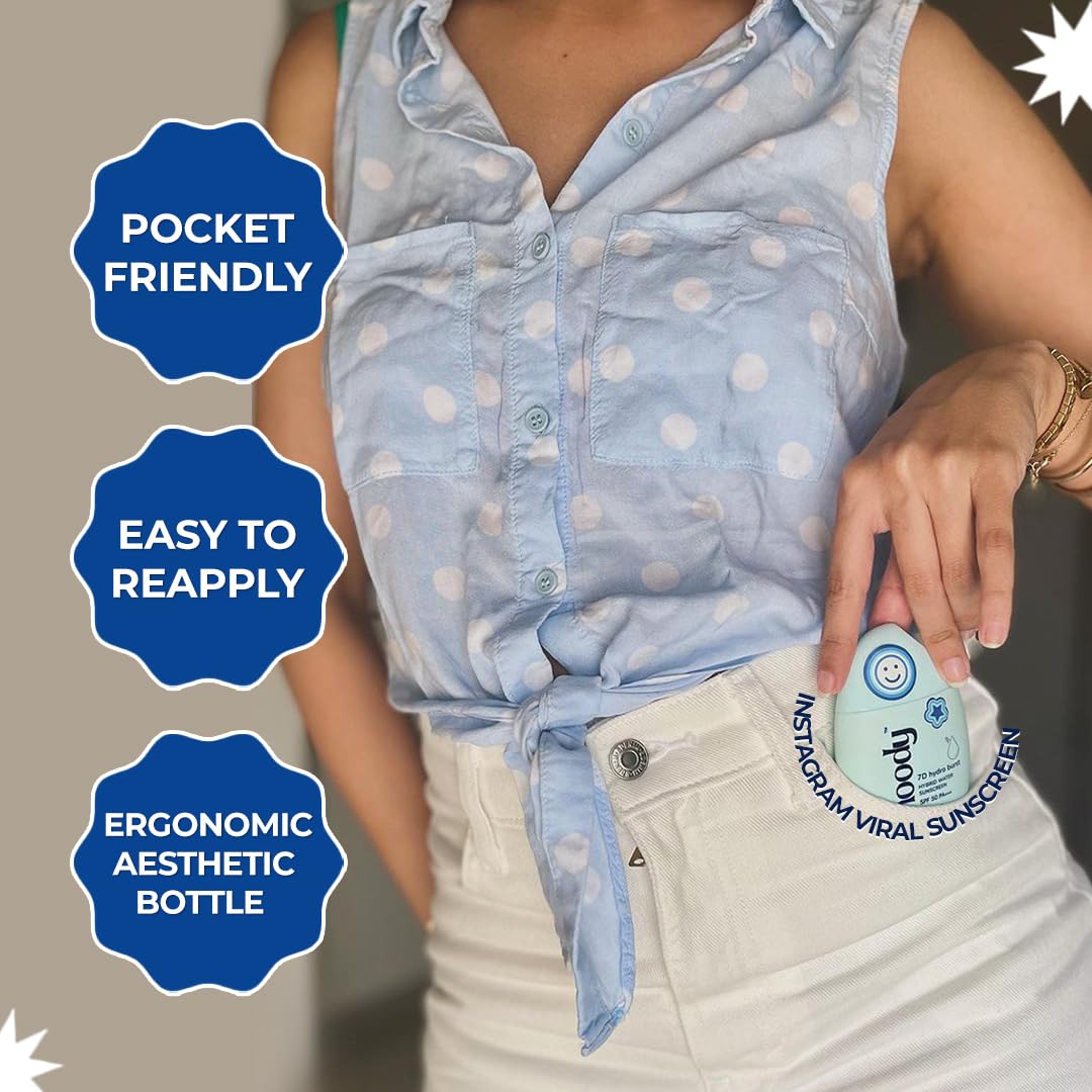 Person holding a small bottle of sunscreen with text labels on a neutral background