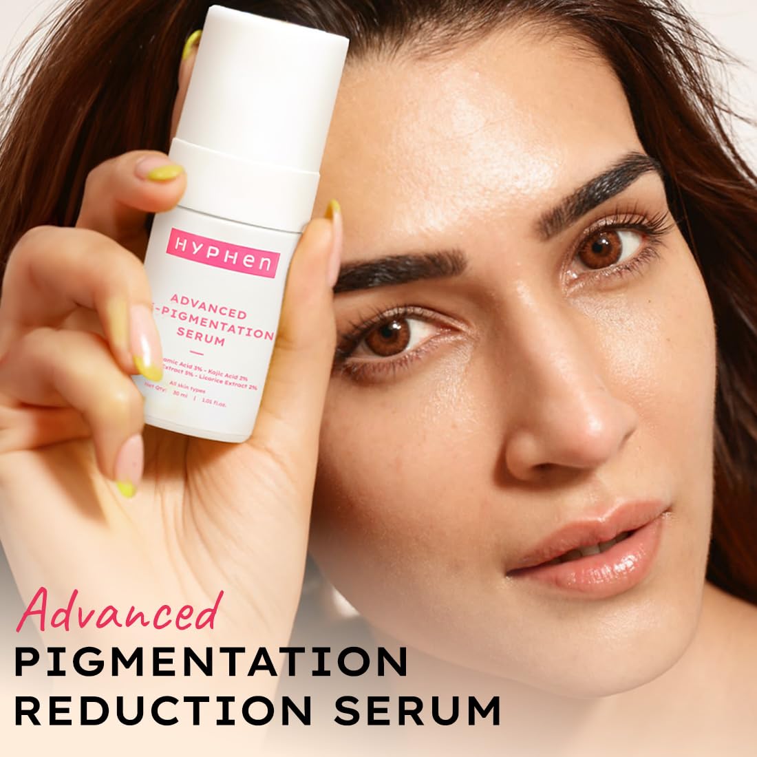 Woman holding a bottle of HYPHEN Advanced Pigmentation Reduction Serum close to her face.