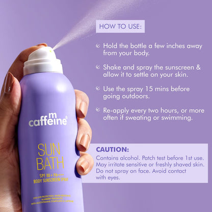 Hand holding a purple sunscreen spray bottle labeled 'cafe m caffeine Sun Bath' with usage instructions on a purple background.