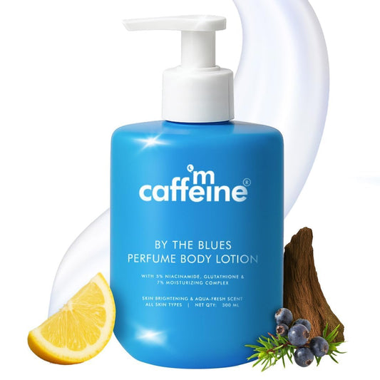 Blue bottle of 'caffim caffeine' perfume body lotion with lemon, berries, and wood elements on a white background