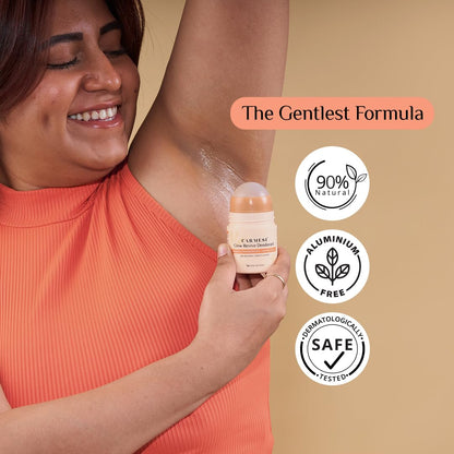 Woman applying deodorant with a container labeled 'The Gentlest Formula' on a beige background.