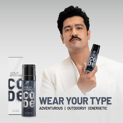 Man holding Wild Stone Code deodorant with product packaging on a gray background