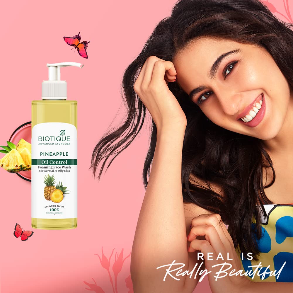 Biotique Pineapple Oil Control Face Wash with a woman on a pink background