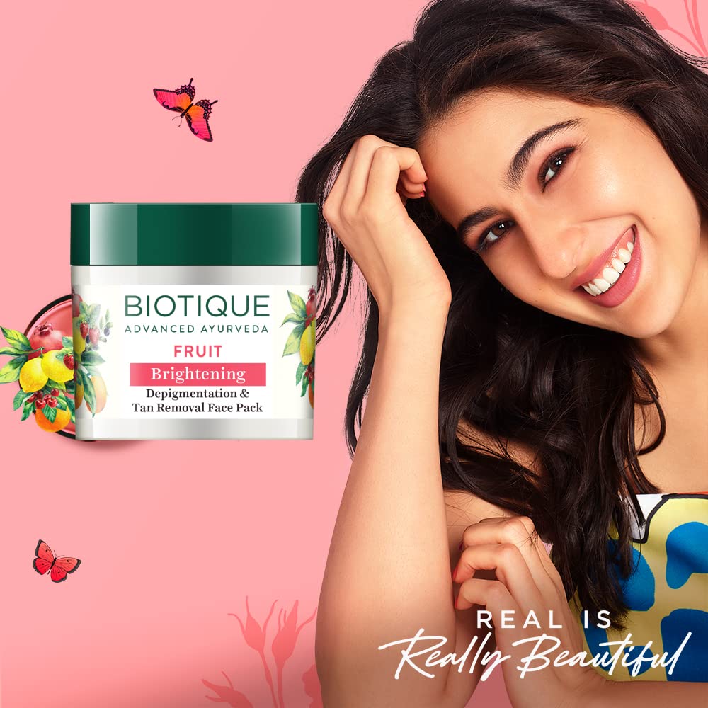 Biotique fruit brightening face pack with a woman on a pink background