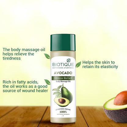Biotique Avocado Stress Relief body massage oil bottle with avocado on a wooden surface