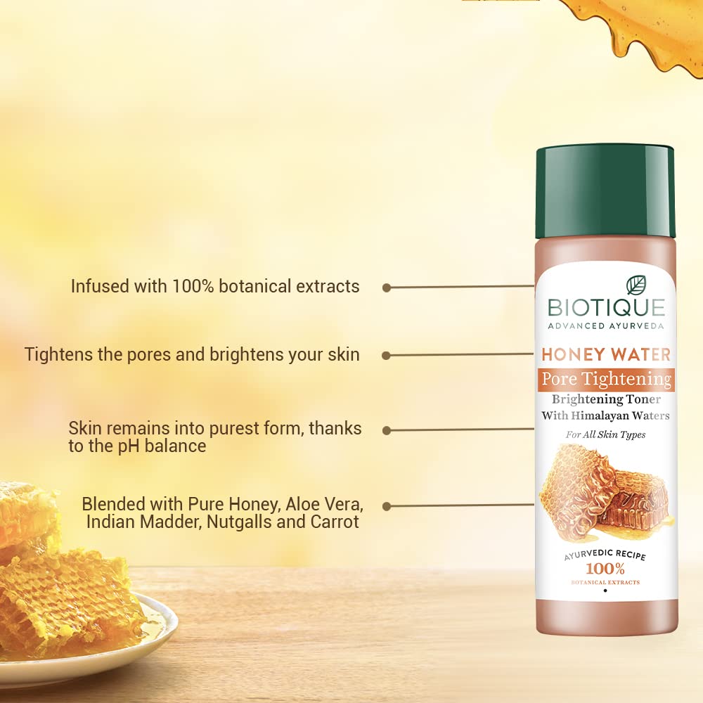 Biotique Honey Water toner bottle with honeycomb and honey on a yellow background