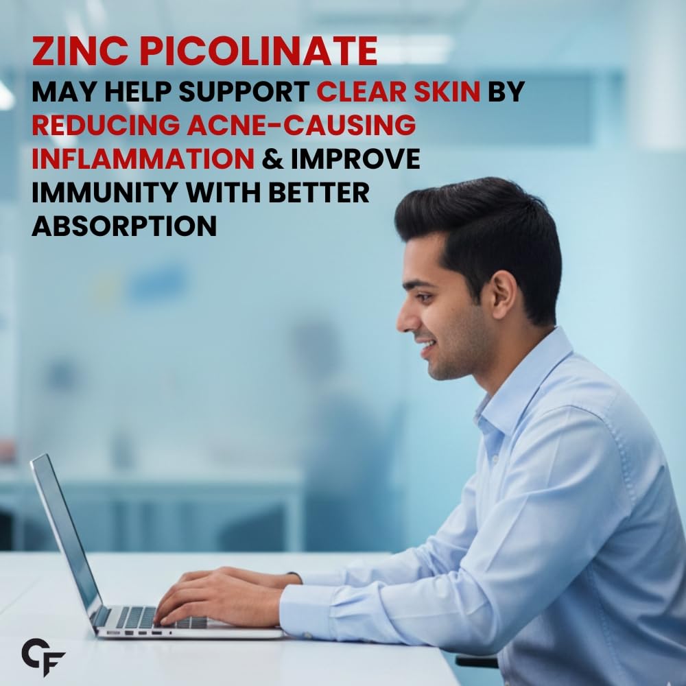 Man using a laptop with text about zinc picolinate benefits on a blurred office background