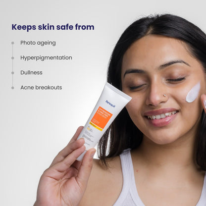 Woman applying sunscreen cream with a tube labeled 'Balea' on a light gray background.